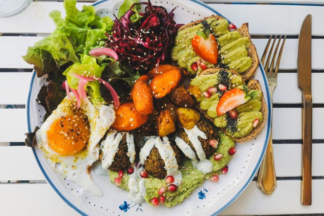 Falafels dorés posés sur une assiette avec des quartiers de citron